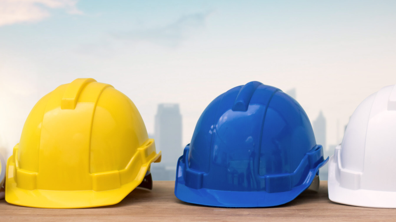 helmet on table with city background, protection and under construction building concept