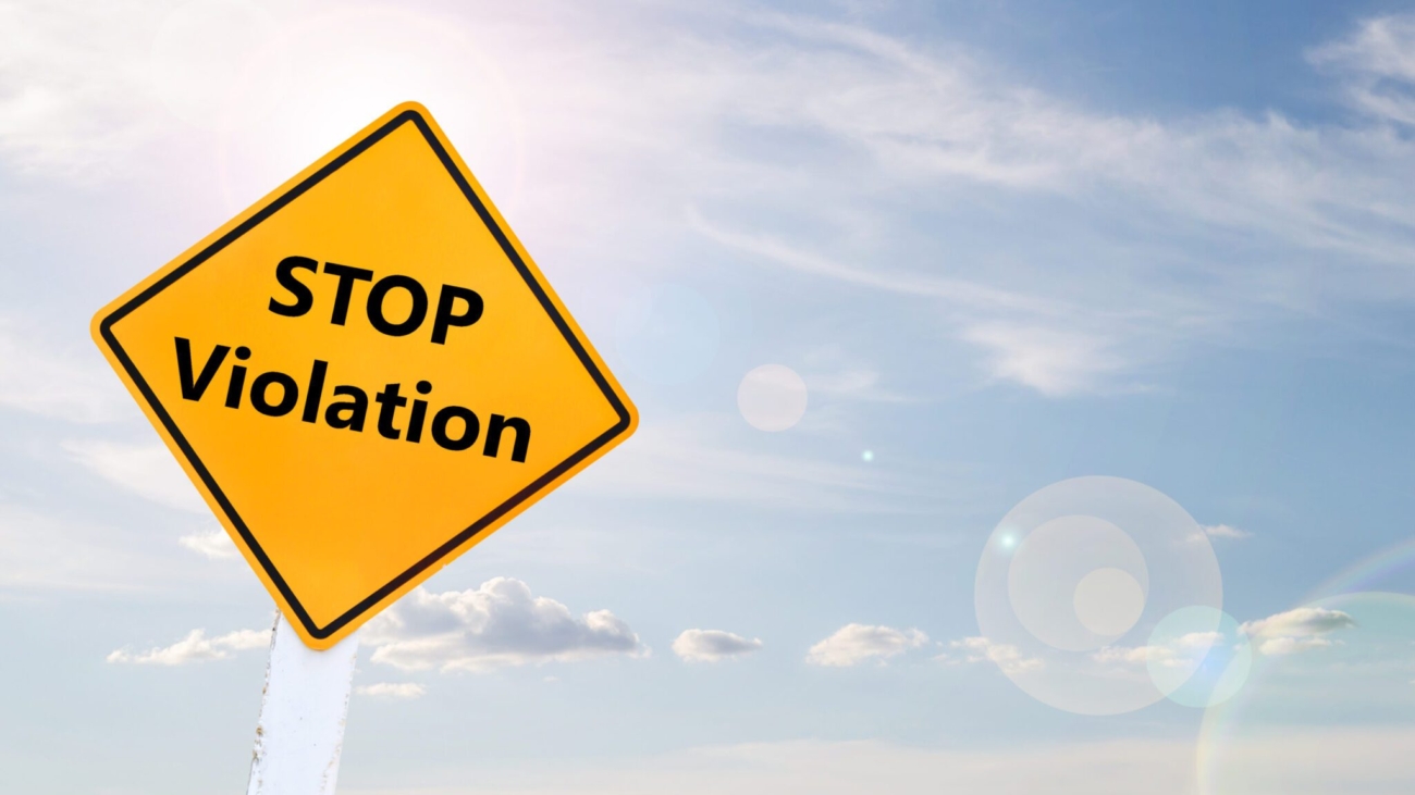 Text for STOP Violation on yellow road sign with blur blue sky background