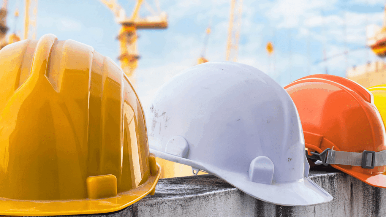HARDHATS ON A LEDGE ON A CONSTRUCTION SITE
