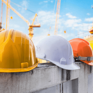 HARDHATS ON A LEDGE ON A CONSTRUCTION SITE