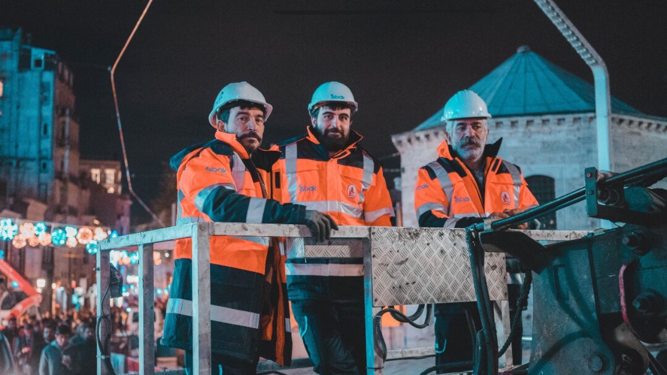 Construction workers at night in the winter